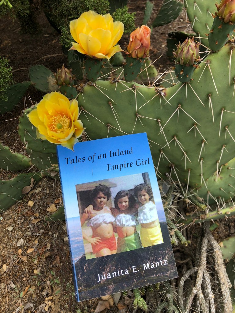 Image of the book cover of "Tales of an Inland Empire Girl" set against a prickly pear cactus.